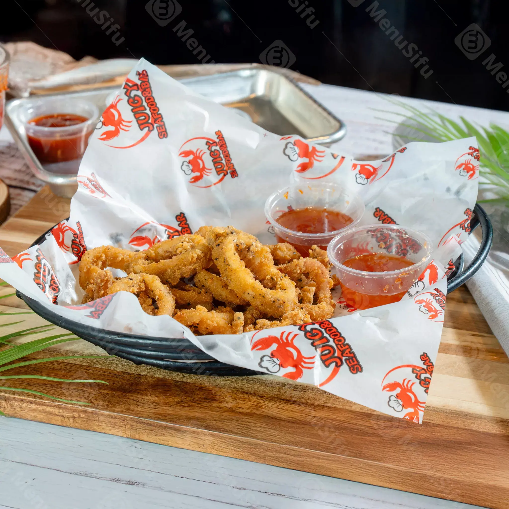 Fried calamari rings with dipping sauces at Juicy Seafood And Bar, a Seafood Restaurant in TX
