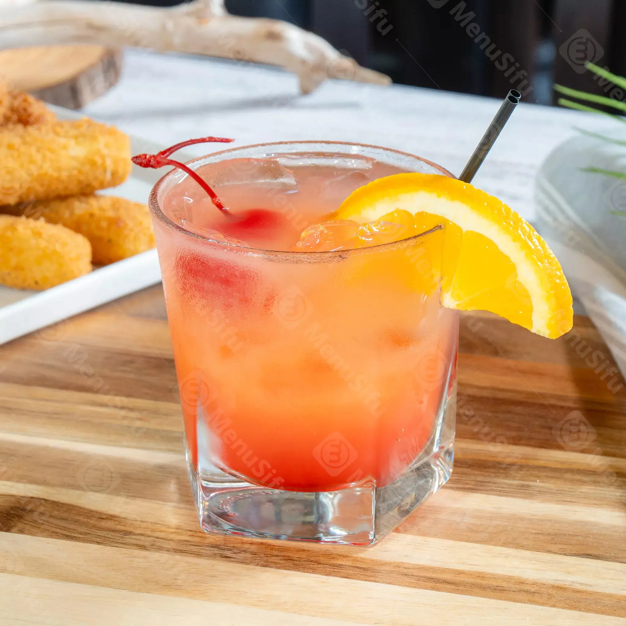 Fruity cocktail with orange slice and cherry at Juicy Seafood And Bar, a Seafood Restaurant in TX
