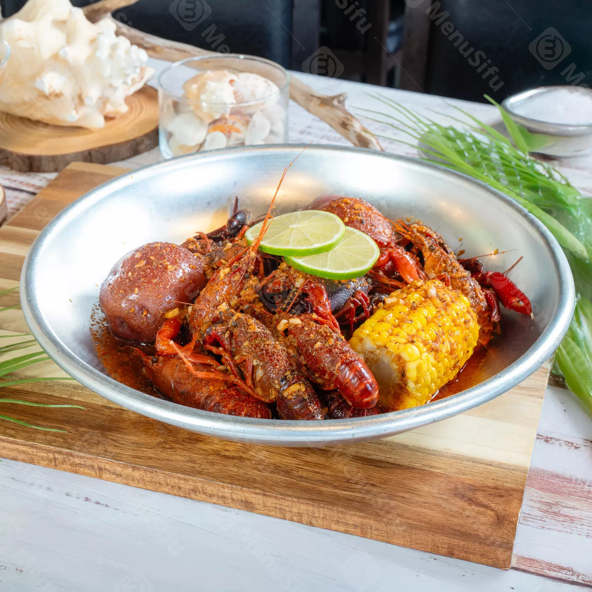 Crawfish boil with corn and potatoes at Juicy Seafood And Bar, a Seafood Restaurant in TX